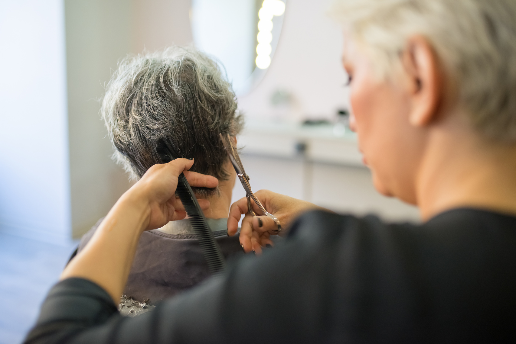 Hair Stylist Cutting the Hair of the Customer