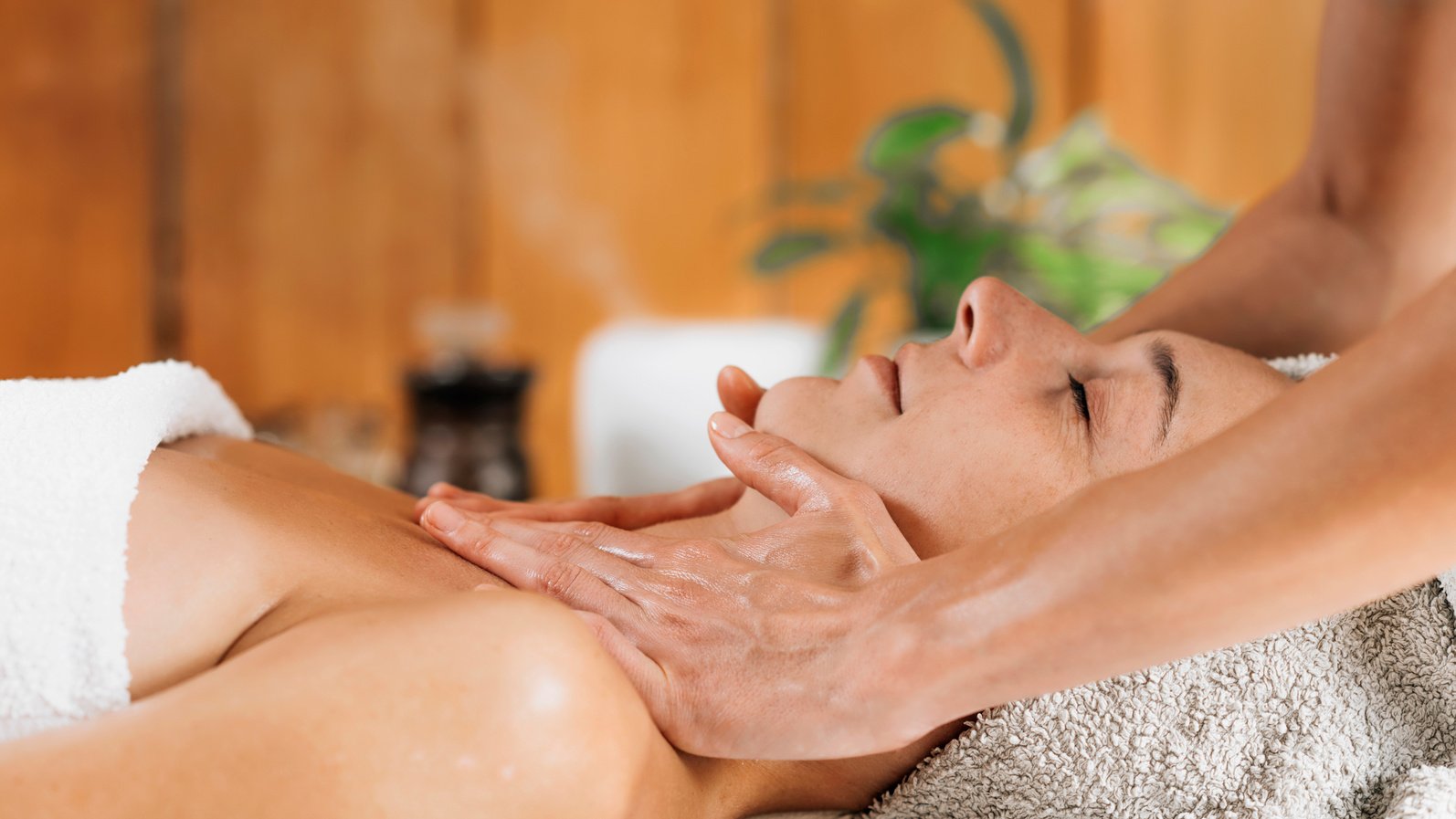 Woman Enjoying Professional Ayurveda Neck And Shoulders Massage With Ethereal Oil